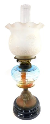 An early 20thC Duplex Art Nouveau oil lamp, an embossed copper base, blue glass reservoir, with chimney and floral frosted glass frilled shade, 56cm high.