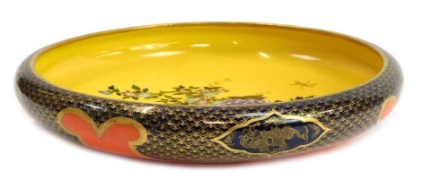 A Soho Pottery Ltd Cobridge Solianware bowl in the Sheraton pattern, decorated centrally with flowering branches and vase in coloured enamels with gilt highlights against a yellow ground, the exterior decorated with a gilt heightened scale pattern with dr