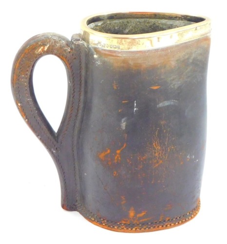 An early 20thC leather jug, with silver rim, stamped to underside Ross Winchester, Sheffield 1906, 19cm high.