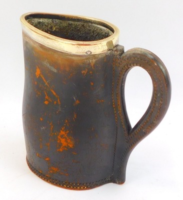 An early 20thC leather jug, with silver rim, stamped to underside Ross Winchester, Sheffield 1906, 19cm high. - 2