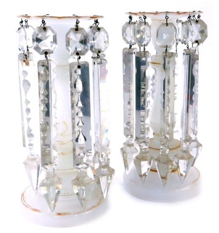 A pair of late 19thC Victorian milk glass lustres, each on a white ground with gilded decoration and petalated top on circular foot, with faceted glass drops, 22cm high.