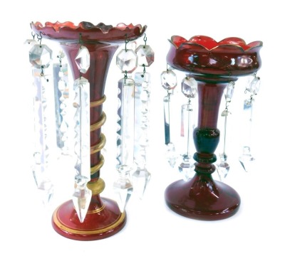 Two similar late 19thC ruby glass lustres, each with a turreted top, on a twisted and gilded stem, on circular foot, with faceted glass drops, 28cm high. (2, AF)