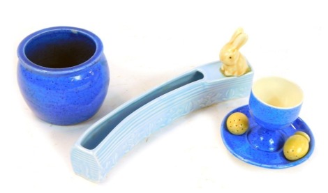 A Moorcroft blue speckle glazed egg cup, the circular stand foot incorporating two egg shaped salt and pepper shakers, the foot stamped Moorcroft Burslem, together with a Sylvac rabbit posy holder, stamped number 1479, in blue glaze, and a blue speckle gl