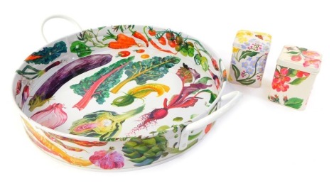 An Emma Bridgewater enamel two handled tray in the Vegetable Garden pattern, 39cm diameter, together with two small enamel tins in the Blossom and Forget Me Not and Primrose pattern, 10cm high.