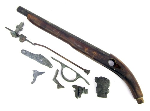 Various gun parts, to include a pistol stock, cast metal gun hardware, steel rod, etc.