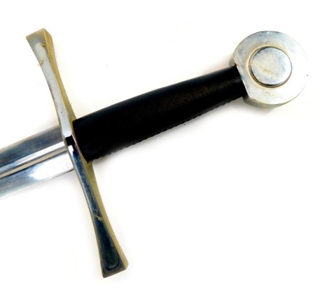 A reproduction medieval broad sword, with circular steel pommel, black leather hand grip and straight blade, with a steel and leather scabbard, length of blade 83cm, sword length 106cm overall.