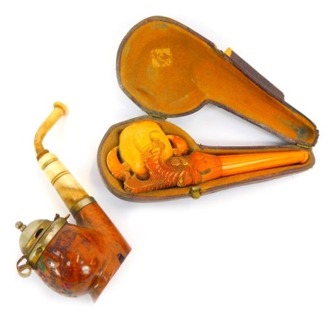 A late 19thC meerschaum pipe, with amber cheroot, modelled as a claw holding central bowl, in leather case, together with a further wooden and bone pipe, decorated with flowers and inscribed St Anton, EST ERZ JE Bruyere.