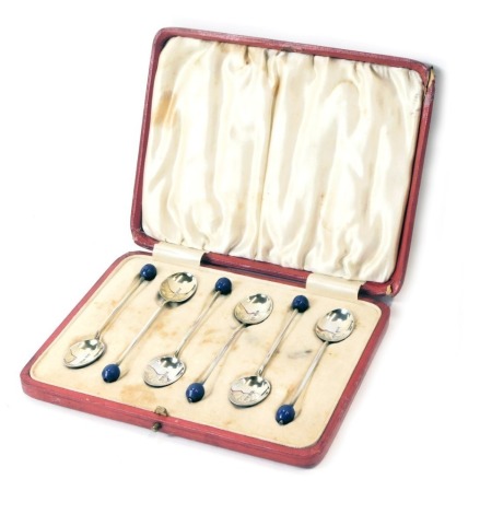 A set of six George V silver bead topped and enamel spoons, each set with a blue bead top and Royal blue enamel shell back, maker HCD, Birmingham 1924, 1.66oz, in fitted case.