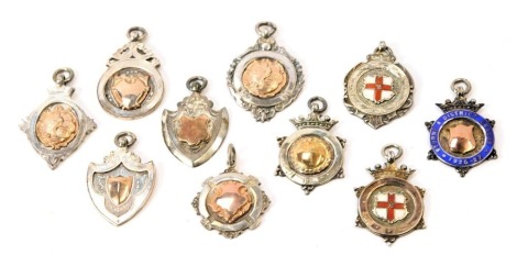 A collection of silver award badges, Bourne & District, c1920 and later, some enamel set with Blue District leaf border, or St Georges Cross, 2.39oz gross. (9 medals)