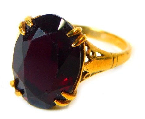 A dress ring, set with oval garnet in four double claw setting, yellow metal stamped 9ct, size L, 2.4g all in.