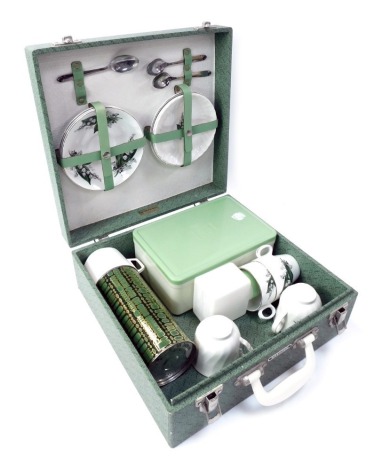 A Brexton picnic hamper, in green, with contents, to include thermos flask, teacups and saucers, etc.