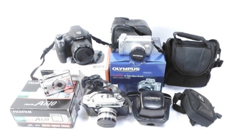 A group of cameras, to include a Sony Cybershot DSC-H400, an Olympus digital compact camera, Yashica camera, etc.