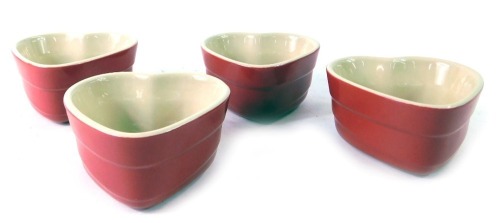 Four Le Creuset red love heart ramekin dishes, 9cm wide.