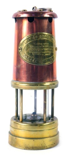 A British Coal Mining Company oil lamp, brass and copper with applied panel for the Aberaman Colliery, serial number 23057, 22cm high.