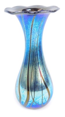 An Alum Bay Isle of Wight blue iridescent glass vase, with a petalated rim, bearing label, 23cm high.