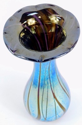 An Alum Bay Isle of Wight blue iridescent glass vase, with a petalated rim, bearing label, 23cm high. - 2