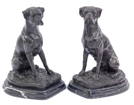 A pair of mid 20thC bronzed figures of boxer dogs, each on a stepped marble base, 22cm high.