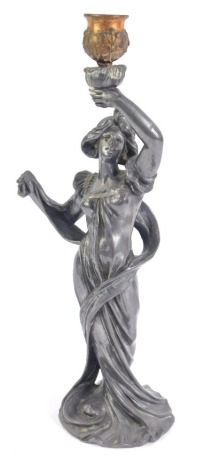 After Emile Bruchon (French 1800-1895). Nouveau figural pewter candlestick, lady in a diaphanus dress, modelled standing holding aloft coopered metal candle holder, titled to base L'Aurore, 33cm high.