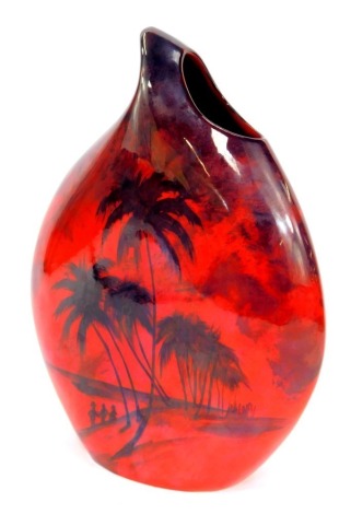 A Peggy Davies ceramics red and black ombre vase, artist's trial signed by Peter Day, on a red ground decorated with black painted figures and beach with palm trees, 30cm high.