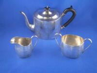 A silver three piece tea set