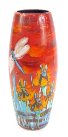 An Anita Harris art pottery ovoid vase, of cylindrical outswept form, on a red and orange ground decorated with blue flowers and a silver dragonfly, 27cm high.