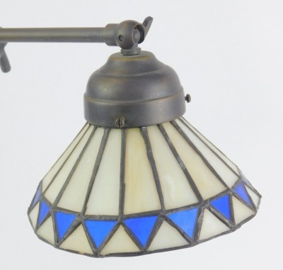 A Tiffany style table lamp, the adjustable arm with a cream and blue diamond Tiffany style shade, on a stepped circular foot base, 43cm high. - 3