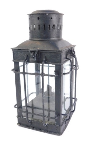 A 20thC lantern, overpainted in black, of square set form with caged detail over panelling, 34cm high.