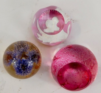 Three glass paperweights, comprising a Caithness Prince and Princess of Wales limited edition number 10/500 pink glass paperweight, a Caithness Celebration weight, and a Hafod Grange paperweight 1995 thistle weight. (3) - 2