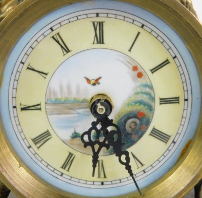 A 19thC French style mantel clock, the circular dial bearing Roman numerals above a painted panel of figures fishing and playing instruments, the case surmounted with a seated figure of lady with corn, a tapering rectangular base, set to the front with a - 2