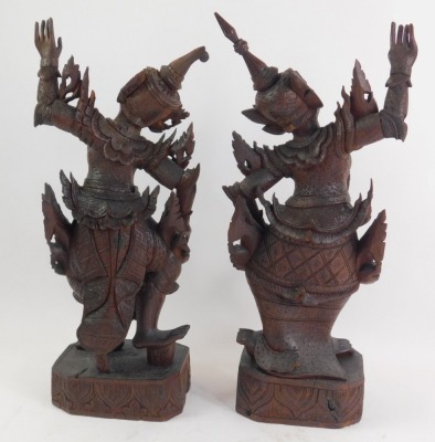 A pair of early 20thC carved South East Asian Yaksha carved figures, each depicting goddess dancing, on a rectangular base, 53cm high. - 2