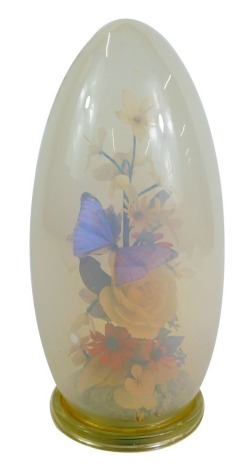 After Michael Curzon. A flower and butterfly display, with opaline glass dome, on Perspex foot, bearing label, 31cm high.