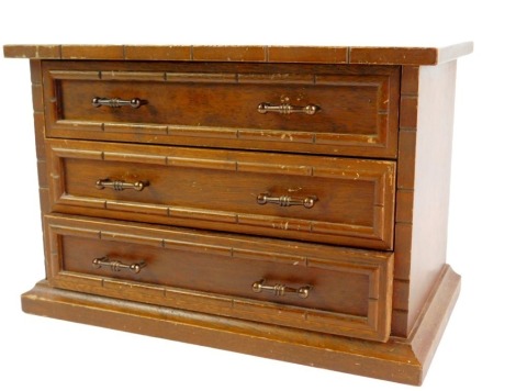 A Victorian oak apprentice chest, of three long drawers, raised on a plinth base, 19cm high, 29cm wide, 15cm deep.