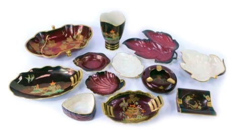 A group of Carlton Rouge Royale wares, to include vases, pin dishes, ashtrays, etc., each decorated on a red ground with Oriental buildings, flowers and animals.