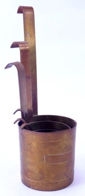 A set of six brass barrel measuring cups, each with arched hook handle, going from 1cl to half a litre, 26.5cm high. - 2