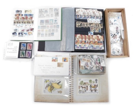 Philately. A collection of George V, George VI, QEII, World and UK postage stamps, enclosed in two albums and loose, together with a small group of first day covers. (a quantity)