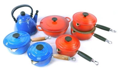 A collection of Le Creuset and Cousances pots and pans, comprising a red Le Creuset casserole dish and cover, set of three red Le Creuset lidded saucepans, two blue Cousances saucepans, and a blue Le Creuset kettle. (1 box)