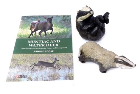 Two Rosemarie Cooke studio pottery badger figures, in standing, and seated pose, the largest 11cm high, together with Cooke (Arnold) Muntjac and Water Deer A Natural History Environmental Impact and Management paperback book.