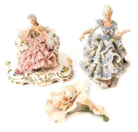 Two Continental porcelain crinoline figures, depicting a lady in flowing dress, with blue and pink detail, and a Franklin Mint porcelain flower, the largest figure 12cm high.