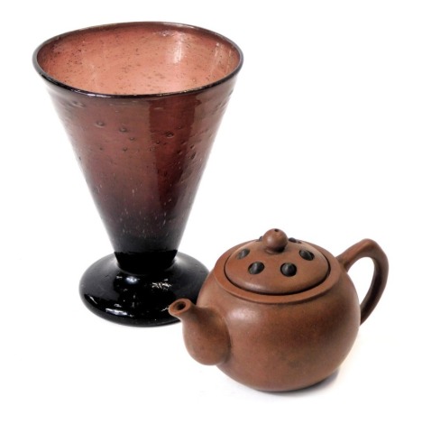 Two ceramics, comprising a 19thC soda glass drinking vessel, 12cm high, and a brown treacle glazed Chinese Yixing teapot, with seal mark to base, 7cm high. (2)