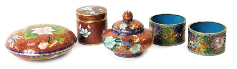 Oriental cloisonne wares, comprising miniature jar and cover, 6cm high, two blue napkin rings, 3.5cm high, circular jar and cover, 8cm high, and a cylindrical jar and cover, 4cm high. (5)