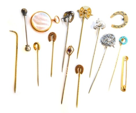 Various tie pins, some with yellow metal tops, mainly plated and silver examples, to include horse's head, horseshoe, imitation watch face, and riding crop, etc. (a quantity)