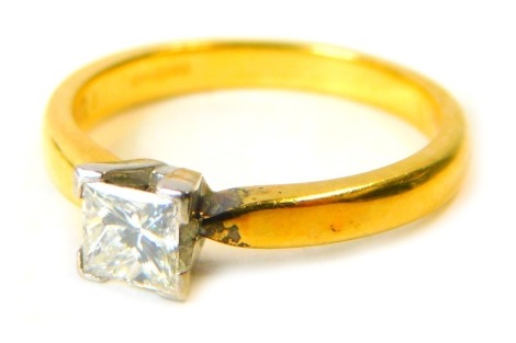 An 18ct gold diamond solitaire ring, the square cut diamond approx 0.50ct, in four point claw white gold setting, on a yellow metal band, ring size N½, 3.9g all in.