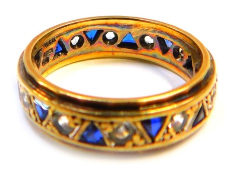 A 9ct gold, sapphire and cz eternity ring, set with round brilliant cut czs and triangle cut sapphires, maker MB, ring size R½, 5.1g all in.