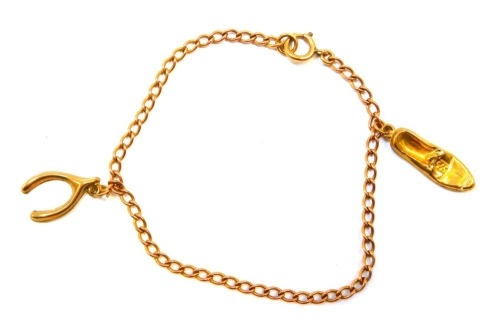 A flattened curb link bracelet, and two charms, comprising ballet shoe and wishbone, yellow metal stamped 9ct, 18cm long, 3.7g.