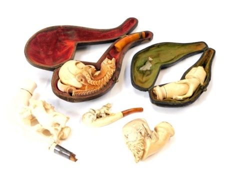 A group of meerschaum type pipe and pipe parts, comprising short handled, long handled, two in fitted case, carvings of horse and figures. (a quantity)