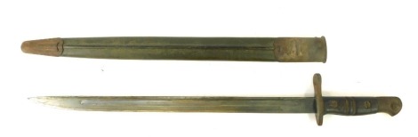 A World War I bayonet, with wired handle grip and steel blade, in material scabbard, stamped IAB with a crown, dated 1913, 2 7 WNGT, 59cm long.