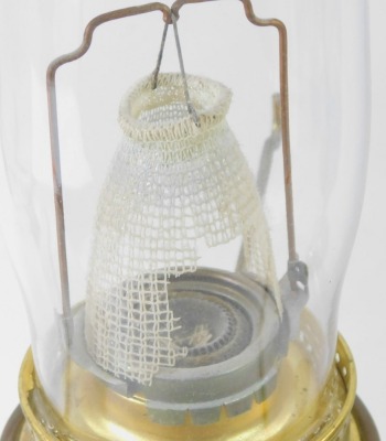 Two oil lamps, comprising one with red flash glass shade and funnel, on chrome finish base, 62cm high, and another with white finish shade, 63cm high. (2) - 2