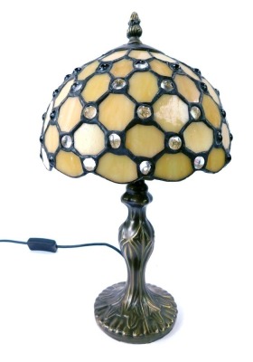 A Tiffany style table lamp, with a pearlescent glass shade, on a bronzed lamp base, 40cm high. WARNING! This lot contains untested or unsafe electrical items. It is supplied for scrap or re-conditioning only. TRADE ONLY