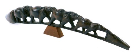 A carved hardwood group of elephants, tusk form, 52cm wide.