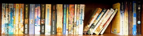 Pratchett (Terry). A collection of fiction to include The Dark Side of the Sun, Sorcery, Pyramids, Wild Sisters, Gyngo, The Light Fantastic, Hogfather, Johnnie and the Bomb, Diggers, Soul Music, Equal Rites, Wintersmith and others. (1 shelf)